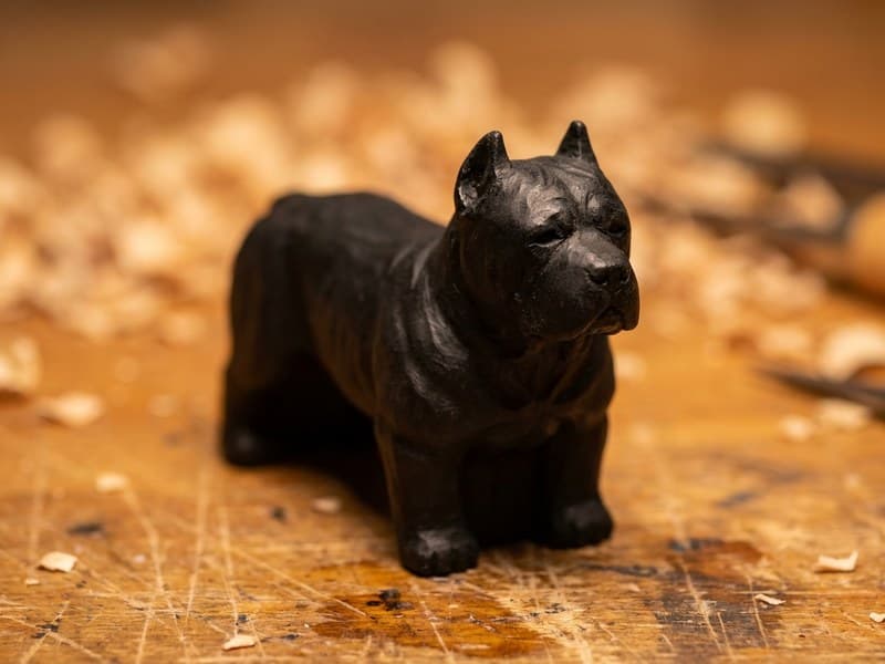 Miniature Cane Corso wood carving finished in matte black with visible muscle definition